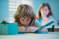 Kid studying at school. Schoolchild doing homework at classroom. Education for kids. Royalty Free Stock Photo