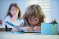 Kid studying at school. Schoolchild doing homework at classroom. Education for kids. Royalty Free Stock Photo