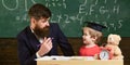 Kid studying with teacher. Father teaches son, discuss, explain. Education concept. Teacher in formal wear and pupil in