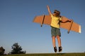 Kid superhero jump anf fly with jetpack. Child pilot play on summer day. Success, leader and winner concept. Imagination