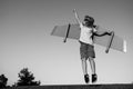 Kid superhero jump anf fly with jetpack. Child pilot play on summer day. Success, leader and winner concept. Imagination
