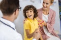 Kid surprised by sweet present from doctor stock photo Royalty Free Stock Photo