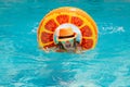 Kid swim with floating ring in swimming pool. Kids summer vacation. Happy child boy with inflatable ring in poolside Royalty Free Stock Photo