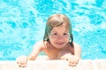 Kid in swimming pool. Little boy playing in outdoor swimming pool in water on summer vacation. Child learning to swim in Royalty Free Stock Photo