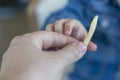 The kid taking from his father's hands the french fries. Junk food. Parents give bad food to the child. Royalty Free Stock Photo