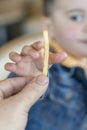 The kid taking from his father& x27;s hands the french fries. Junk food. Parents give bad food to the child. Royalty Free Stock Photo