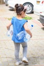 Little child recycling plastic water bottles. World Environment Day.