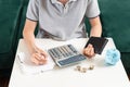 Kid teen boy counting money and taking notes, saving money in a piggy bank. Learning financial responsibility and Royalty Free Stock Photo