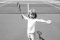 Kid tennis player on tennis court. Boy hitting forehand in tennis. Royalty Free Stock Photo