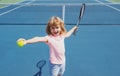 Kid tennis player on tennis court. Boy hitting forehand in tennis. Royalty Free Stock Photo