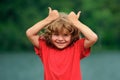 Kid thumbs-up. Child boy approves. Portrait of smiling little boy showing thumbs up.