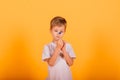 Kid time concept - serious male preschooler enjoying learning about time, holding an hour glass, studio shot Royalty Free Stock Photo