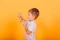 Kid time concept - serious male preschooler enjoying learning about time, holding an hour glass, studio shot Royalty Free Stock Photo