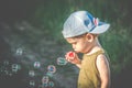 Kid toddler blowing soap bubbles