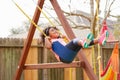 Kid toddler girl swinging on a playground swing Royalty Free Stock Photo