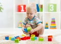 Kid toddler playing wooden toys at home or nursery Royalty Free Stock Photo