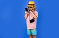 Kid tourist blogger making photo for social networks on phone. Travel with kids, tourism. Royalty Free Stock Photo