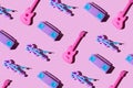 Kid toy guitar, cassette deck player and violin on trendy pastel pink background