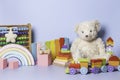 Kid toys collection isolated on blue background. Teddy bear and wooden educational baby toy set. Montessori toys Royalty Free Stock Photo