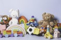 Kid toys collection isolated on blue background. Teddy bear, wooden, plastic and fluffy educational baby toy set. Front Royalty Free Stock Photo