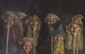 Kid toys witch heads on sticks. With fog and smoke on dark pastel background