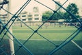 Kid training soccer football in blur background behind the net Royalty Free Stock Photo