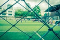 Kid training soccer football in blur background behind the net for soccer and football academy sport training background and Royalty Free Stock Photo