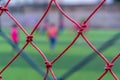 Kid training soccer football in blur background behind the net for sport training and football academy concept Royalty Free Stock Photo