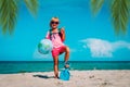 Kid travel on beach, cute girl with backpack and globe on vacation Royalty Free Stock Photo