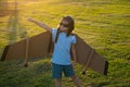 Kid traveller with backpack wings. Child playing pilot aviator and dreams outdoors in park. Dreaming, freedom and