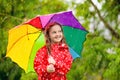 Kid with umbrella playing in summer rain Royalty Free Stock Photo