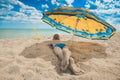 Kid under umbrella on a beach