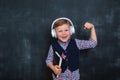 Kid in uniform and headphones holding a flag of United Kingdom and book in hands. Great Britain flag. British flag Royalty Free Stock Photo