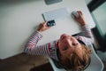 Kid using bank card to pay online, modern technology