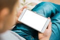 Kid using boy smartphone during a sunny day White screen for mock up Royalty Free Stock Photo