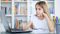 Kid Using Laptop Studying in Video Conferencing, Child Learning, Writing in Library, Blonde Girl Chatting with Teacher, Children H Royalty Free Stock Photo