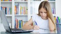 Kid Using Laptop Studying in Video Conferencing, Child Learning, Writing in Library, Blonde Girl Chatting with Teacher, Children H Royalty Free Stock Photo