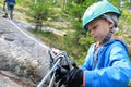 Kid using safety climbing equipment Royalty Free Stock Photo