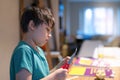 Kid using scissors cutting white paper ,Schoolboy making art and craft for his homework,Child learning how to use the scissors cut Royalty Free Stock Photo