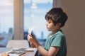 Kid using scissors cutting white paper ,Schoolboy making art and craft for his homework,Child learning how to use the scissors cut Royalty Free Stock Photo