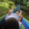 Kid using smartphone on hammock