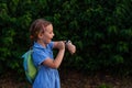 Kid using smartwatch outdoor. Child talking on the smartphone. Schoolgirl using touchscreen on watches browsing internet