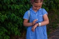 Kid using smartwatch outdoor. Child talking on the smartphone. Schoolgirl using touchscreen on watches browsing internet