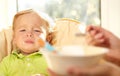 Kid is very disappointmented about porridge. Royalty Free Stock Photo