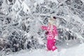 Kid walking and playing in snowy winter forest, winter wonderland, family travel Royalty Free Stock Photo