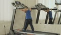 The kid walks on the treadmill