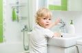 Kid washing hands in bathroom Royalty Free Stock Photo