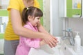 Kid washing hands with mom Royalty Free Stock Photo