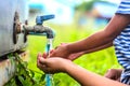 Kid washing hands with mother, selective focus point.