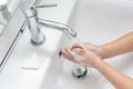 Kid washing hands in a white basin with a bar of white soap Royalty Free Stock Photo